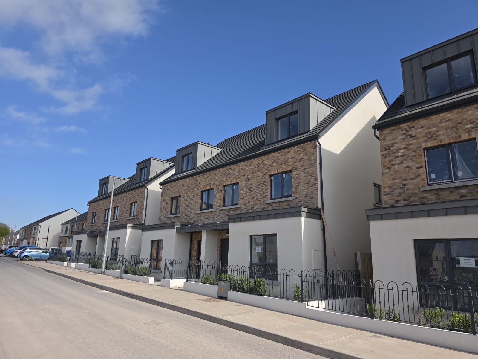 Street of brick and render homes with railings